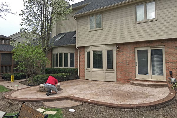 Faded stamped concrete patio in Brantford before sealing