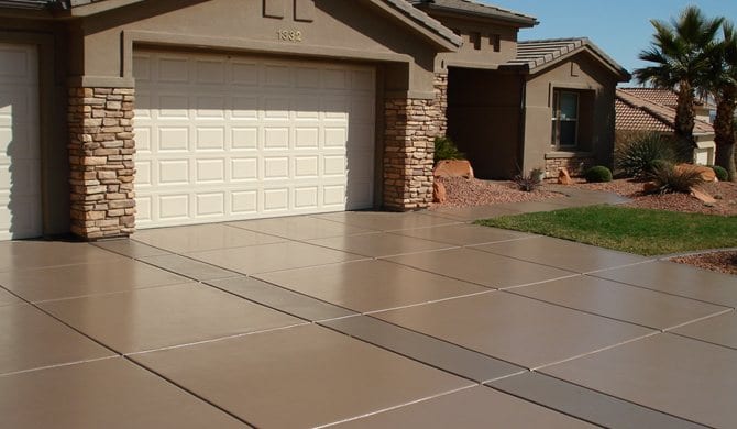 Tan coloured concrete driveway sealed with a semi-gloss finish