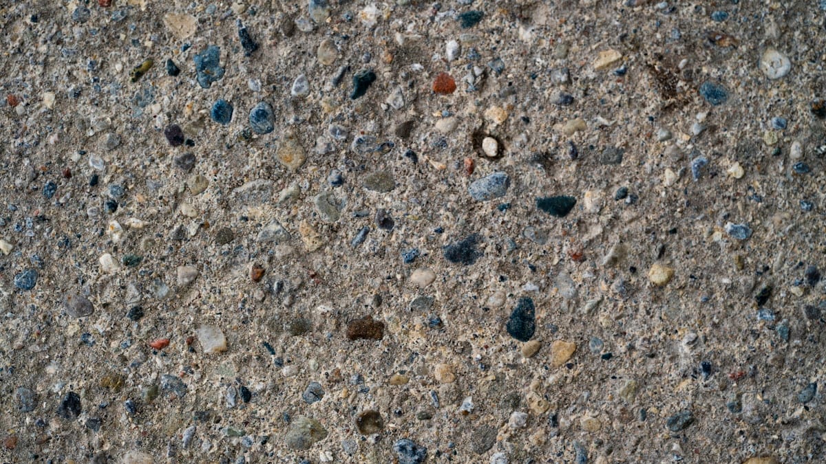 Close-up of sealed exposed aggregate concrete showing enhanced stone colour