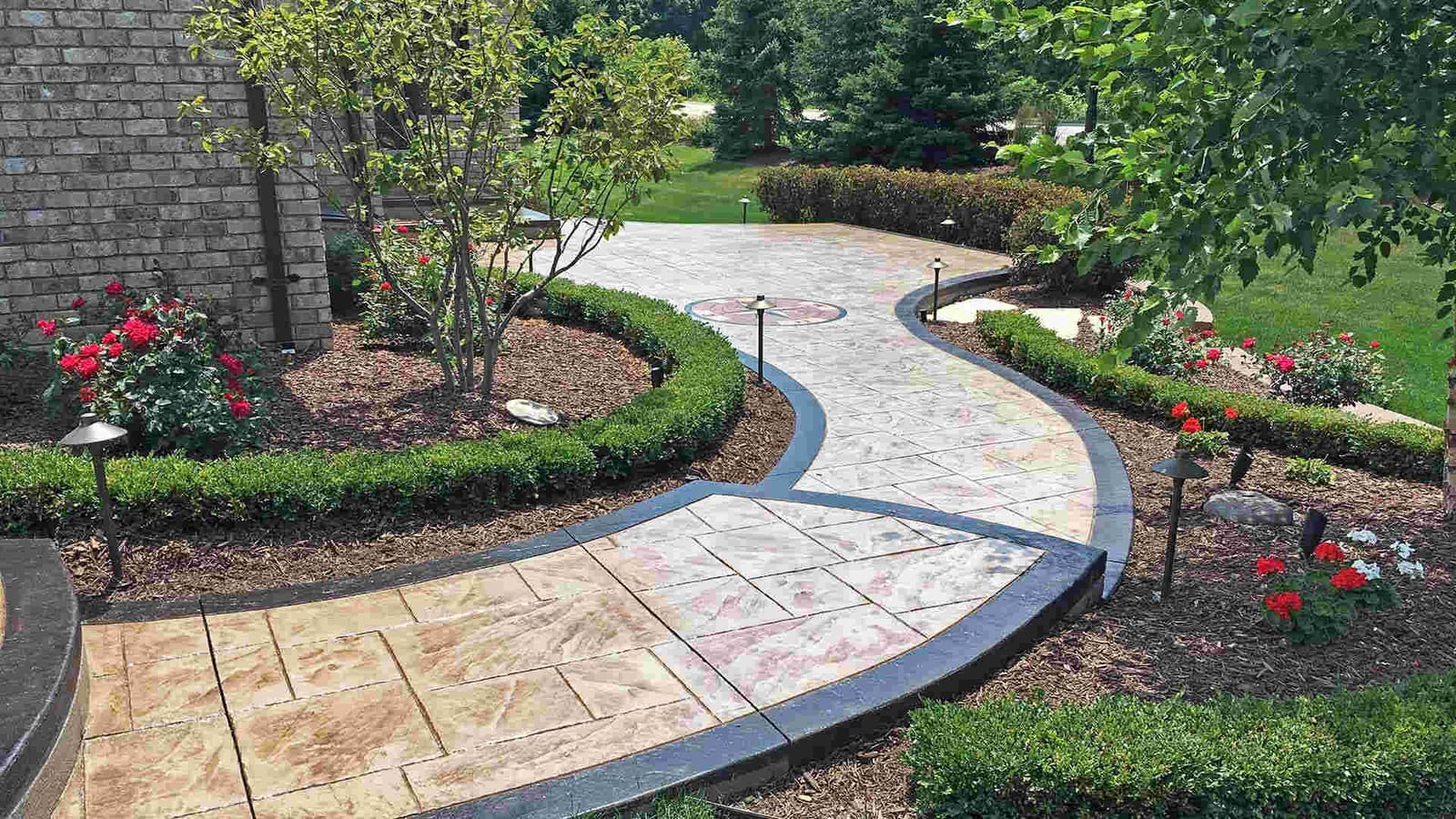 Curved stamped concrete garden walkway with a semi-gloss sealer