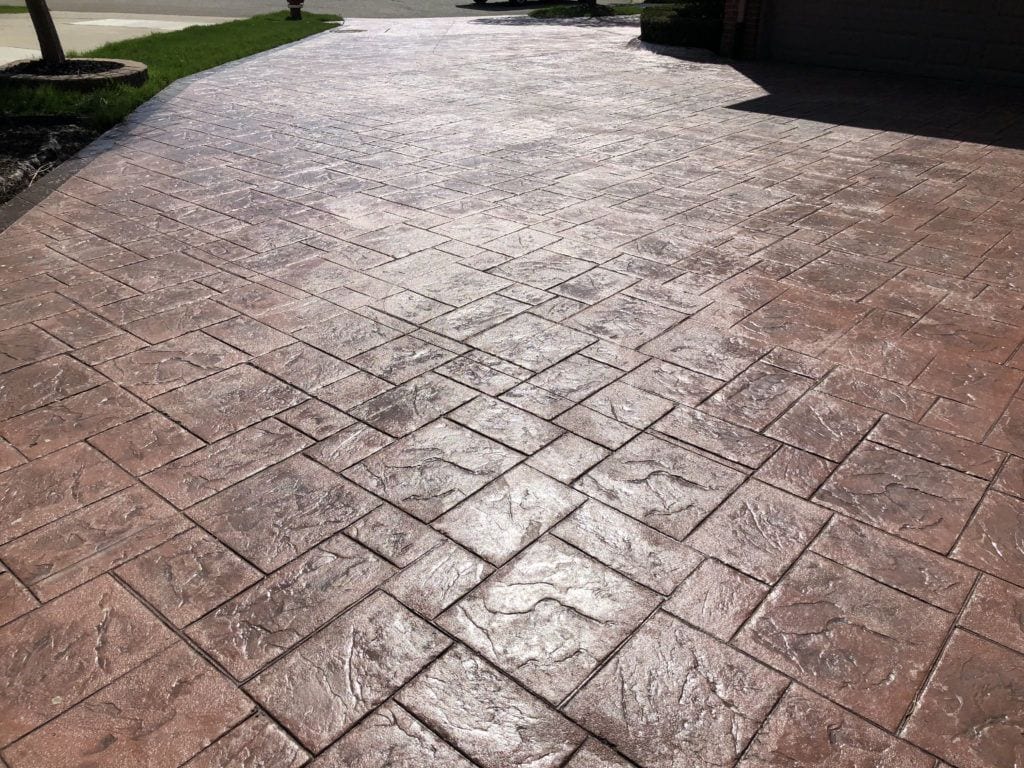 Wet-look gloss sealer on a stamped concrete driveway in Woodstock, Ontario